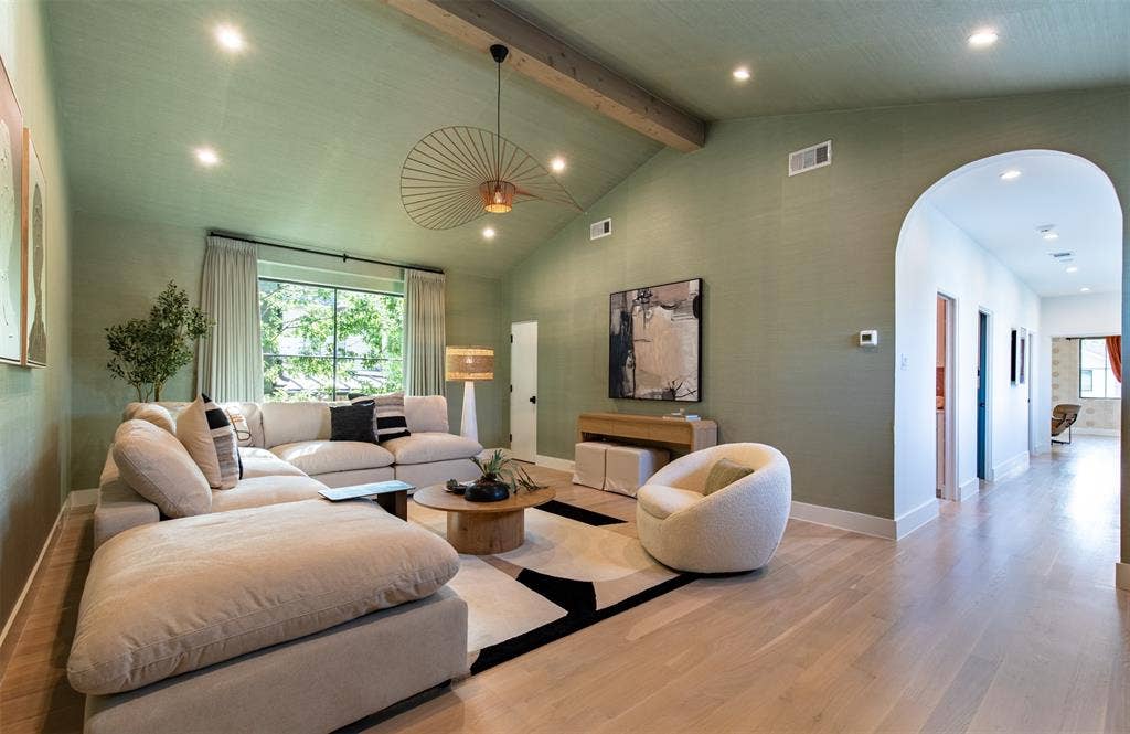 6979 Bob O Link Drive, Dallas, TX 75214 Vaulted ceiling featuring an exposed wood beam, recessed lighting, expansive picture window, arched entryway, and wide-plank wood-finish flooring