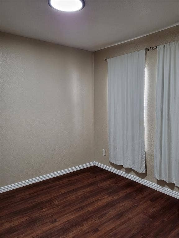 2705 Tanner Street, Dallas, TX 75215 Neutral-toned interior space featuring wood-finish flooring and a flush-mount ceiling light fixture