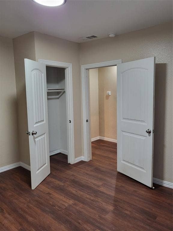 2705 Tanner Street, Dallas, TX 75215 Wood-finish flooring, two-panel arched interior doors, and built-in closet shelving