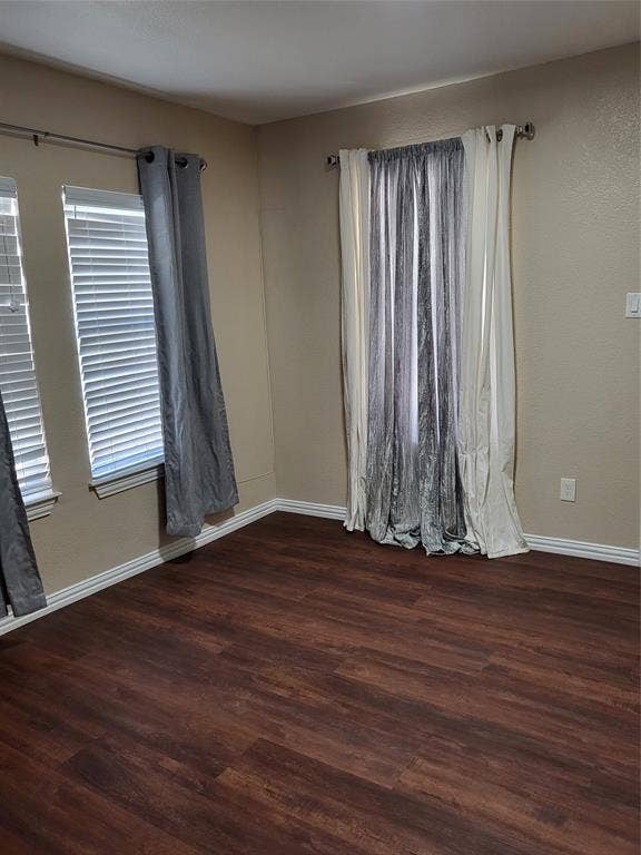 2705 Tanner Street, Dallas, TX 75215 Interior room featuring wood-finish flooring, two multi-pane windows with horizontal blinds, and metal curtain rods