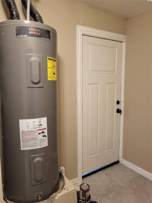 2705 Tanner Street, Dallas, TX 75215 Ruud water heater with an insulated tank and a six-panel door featuring dark hardware