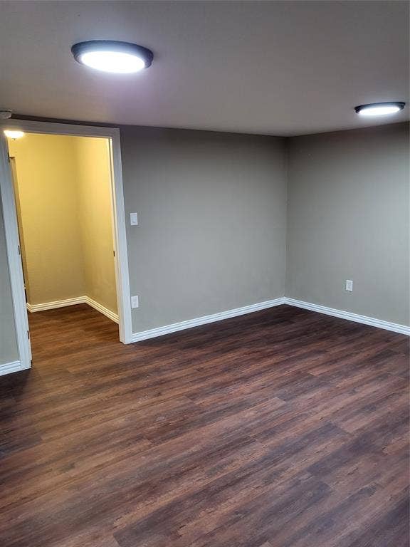 2705 Tanner Street, Dallas, TX 75215 Interior room featuring wood-finish flooring, neutral wall tones, and dual ceiling-mounted light fixtures