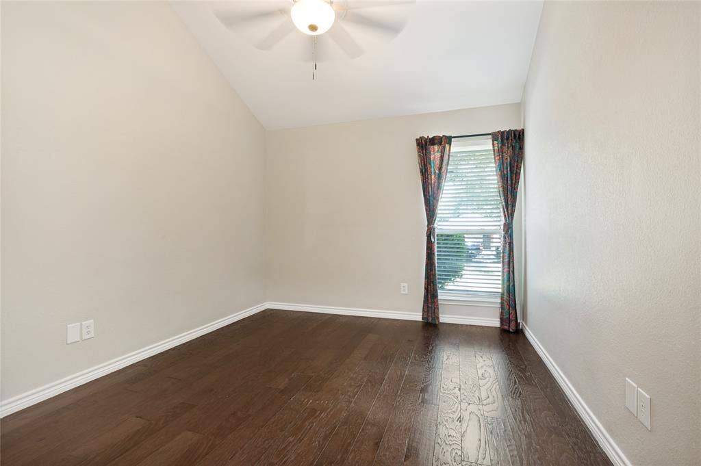 Vaulted ceiling, ceiling fan, wood-finish flooring, single window, window blinds