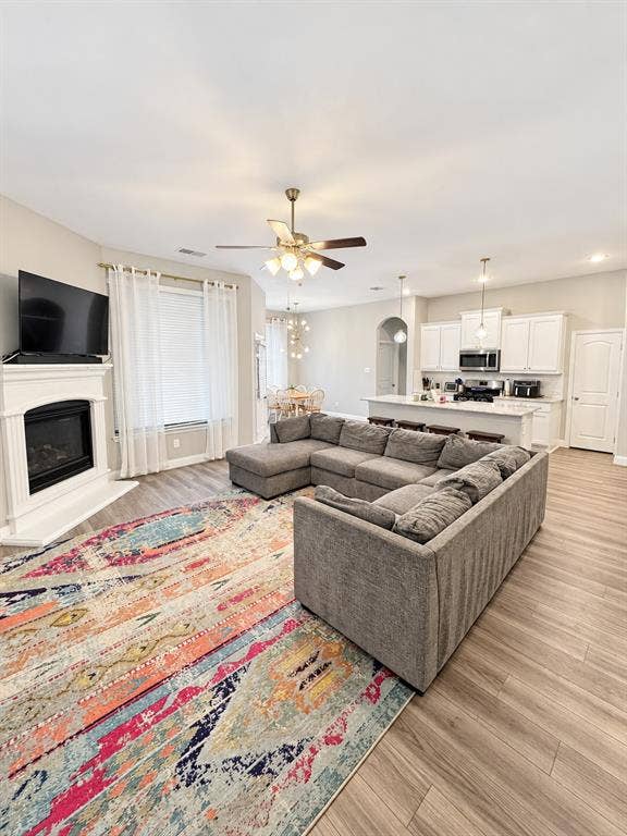 301 Delaford Drive, Forney, TX 75126 Spacious living room with a gas-log fireplace and big windows that fill the space with natural light.