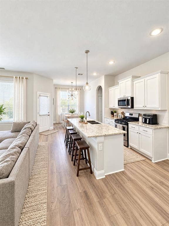 301 Delaford Drive, Forney, TX 75126 Wood-look flooring flows through the open kitchen and dining area for a seamless, modern feel.
