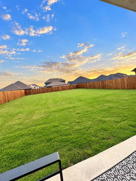 301 Delaford Drive, Forney, TX 75126 Golden-hour views over the massive backyard. Picture your evenings out here on the covered patio.