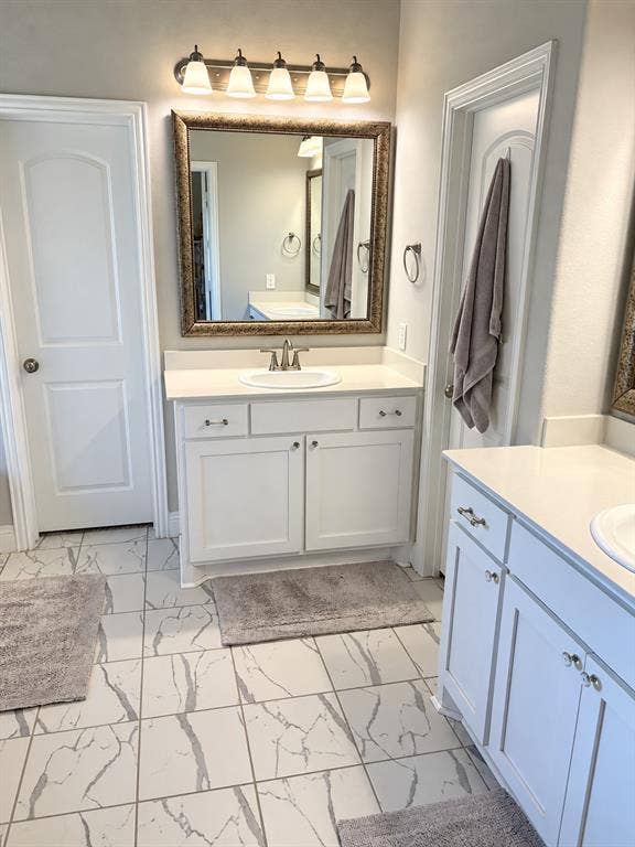 301 Delaford Drive, Forney, TX 75126 Primary bath with dual vanities and tile flooring.