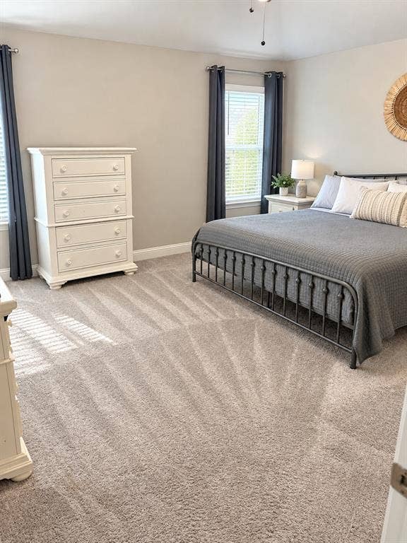 301 Delaford Drive, Forney, TX 75126 Spacious primary bedroom with plush carpet and windows that bring in natural light.