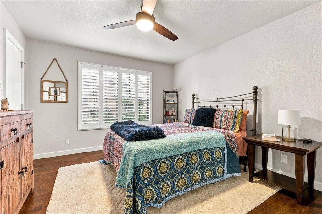 4777 Cedar Springs Road, #9K, Dallas, TX 75219 Wood-finish flooring, plantation shutters, and a central ceiling fan with integrated lighting
