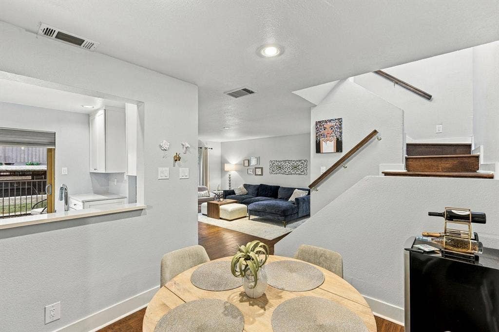 4777 Cedar Springs Road, #9K, Dallas, TX 75219 Open floor plan featuring wood-finish flooring, recessed lighting, and a staircase with a wood handrail