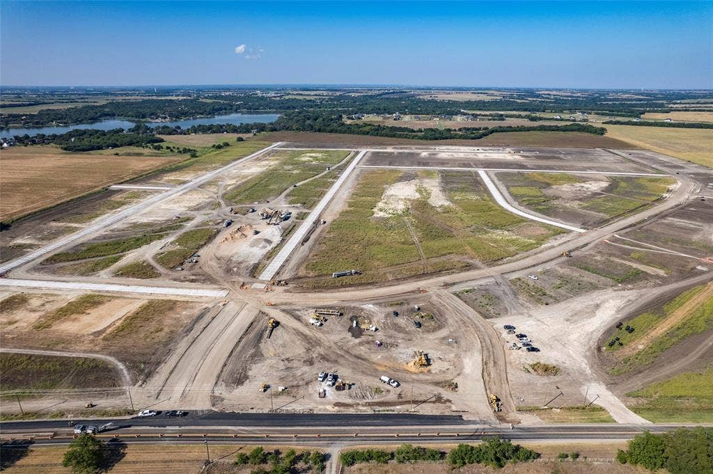 109 Devi Drive, Waxahachie, TX 75165 Large-scale residential development site featuring prepared land parcels, established paved road infrastructure, and water frontage