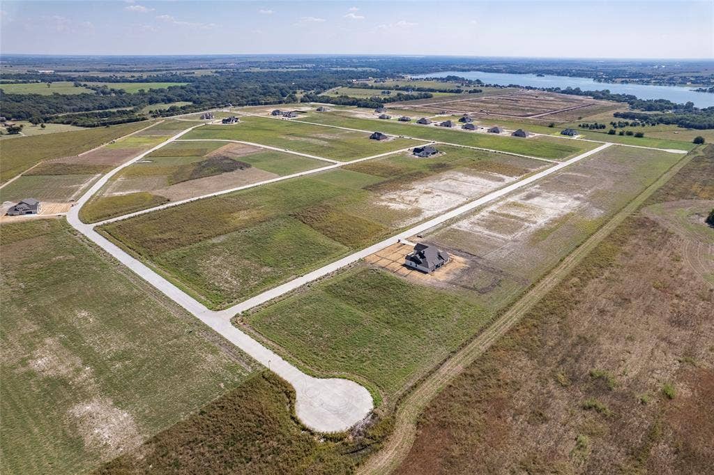 109 Devi Drive, Waxahachie, TX 75165 Aerial perspective of undeveloped land plots featuring paved roads, cul-de-sacs, and proximity to open water