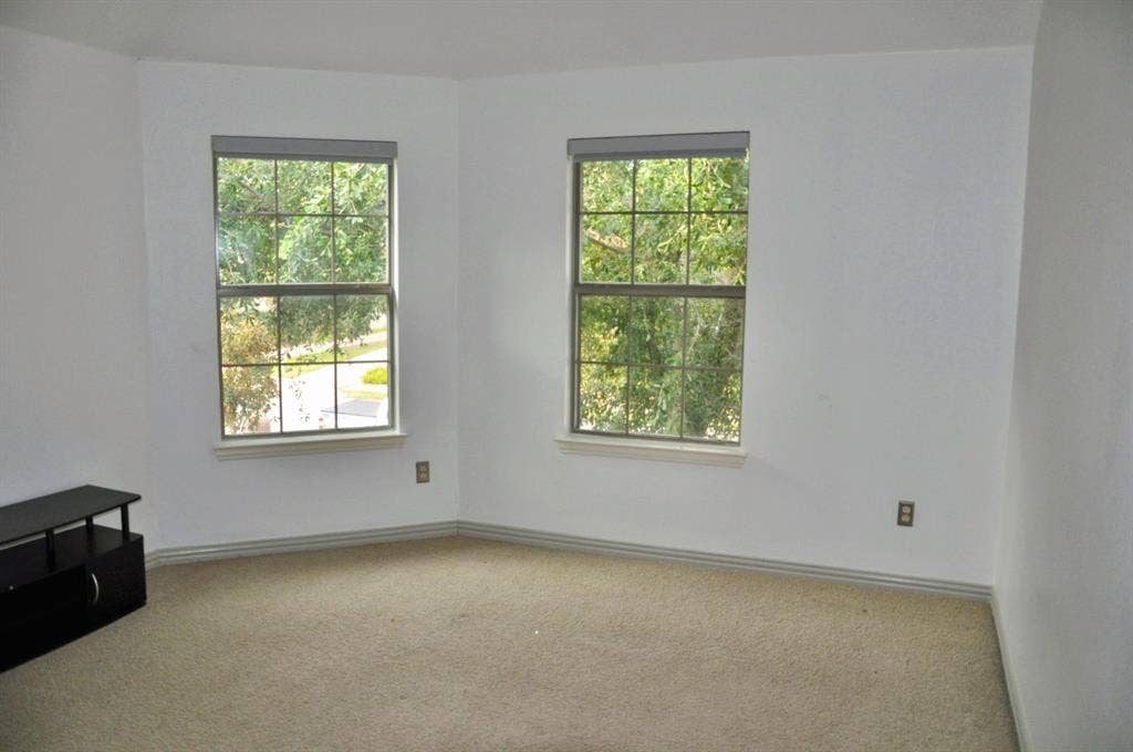 3620 Carlton Court, Sachse, TX 75048 Neutral-toned wall-to-wall carpeting and dual grid-pattern windows featuring built-in roller shades