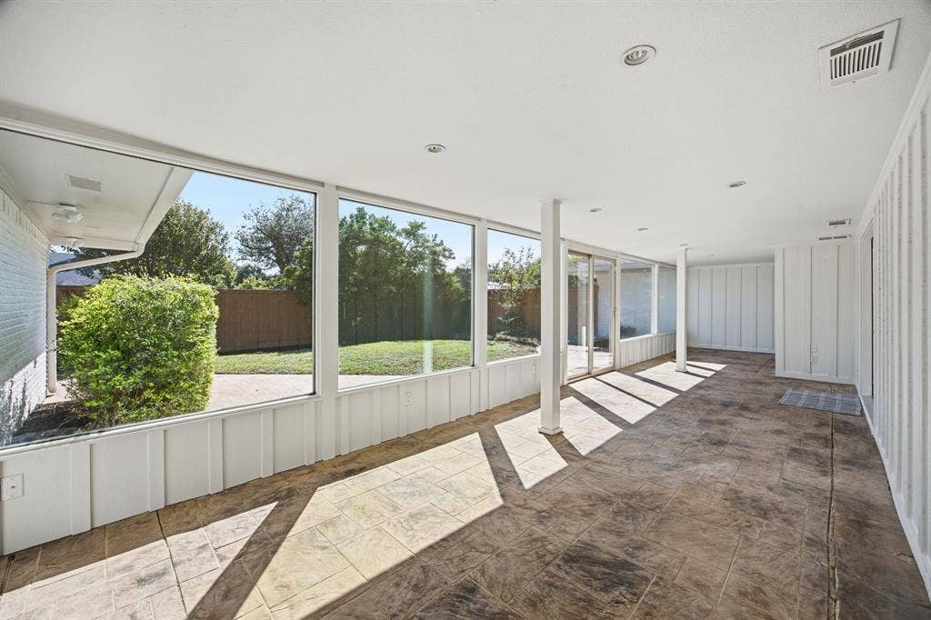 6978 Pemberton Drive, Dallas, TX 75230 Enclosed patio featuring floor-to-ceiling windows, recessed lighting, vertical paneled walls, and stamped concrete flooring
