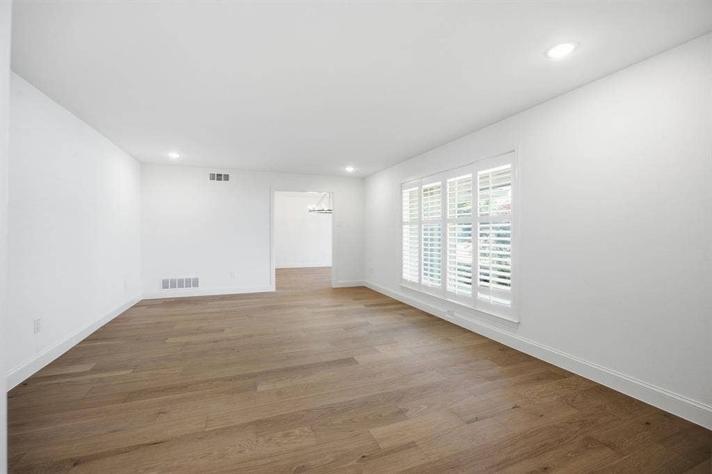 6978 Pemberton Drive, Dallas, TX 75230 Open floor plan featuring wood-finish flooring, recessed lighting, and interior plantation shutters