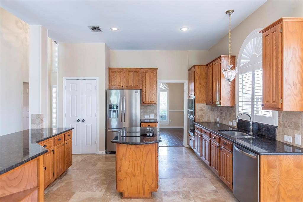 12004 Paducah Drive, Frisco, TX 75035 Well-equipped kitchen with stainless appliances, ample counter space and easy flow to the breakfast area.