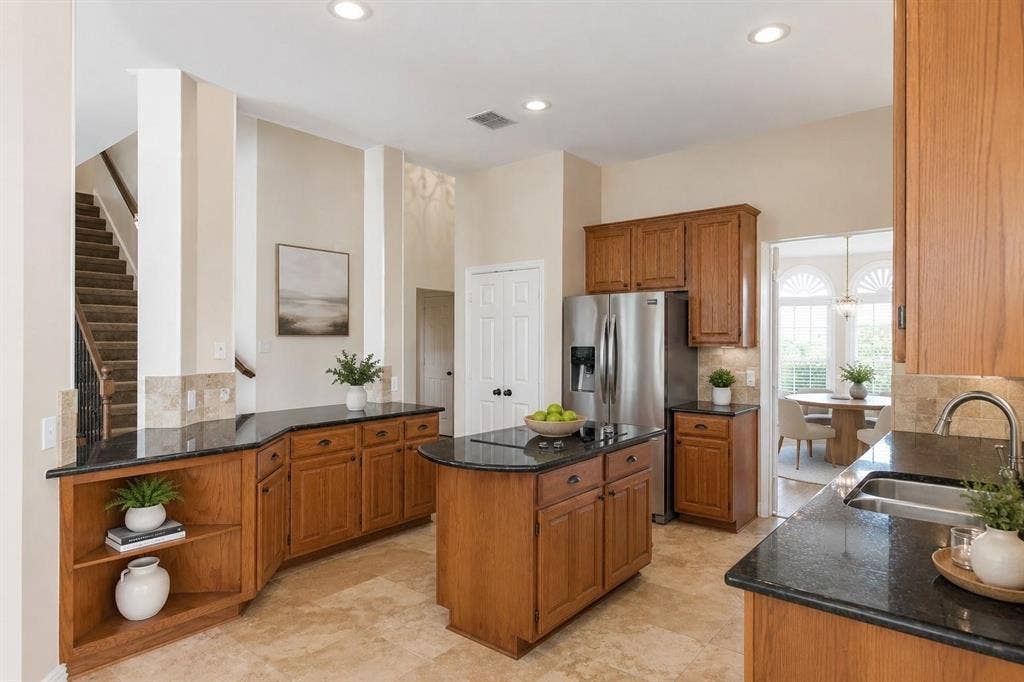 12004 Paducah Drive, Frisco, TX 75035 Chef-inspired kitchen with granite counters, center island, stainless appliances and tons of cabinet storage.