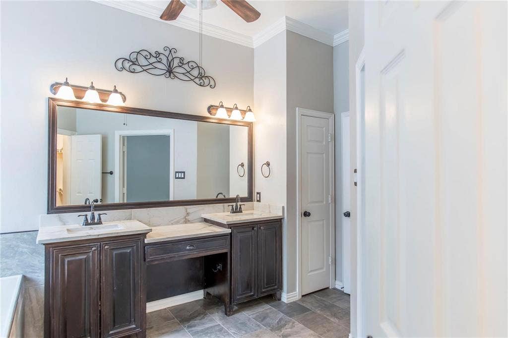 12004 Paducah Drive, Frisco, TX 75035 Spacious bath with double sinks, large mirror and modern lighting.