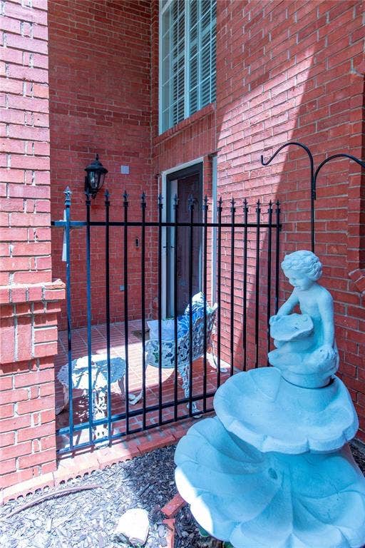 12004 Paducah Drive, Frisco, TX 75035 Charming courtyard entry with decorative wrought-iron gate and fountain accent - a warm welcome home.
