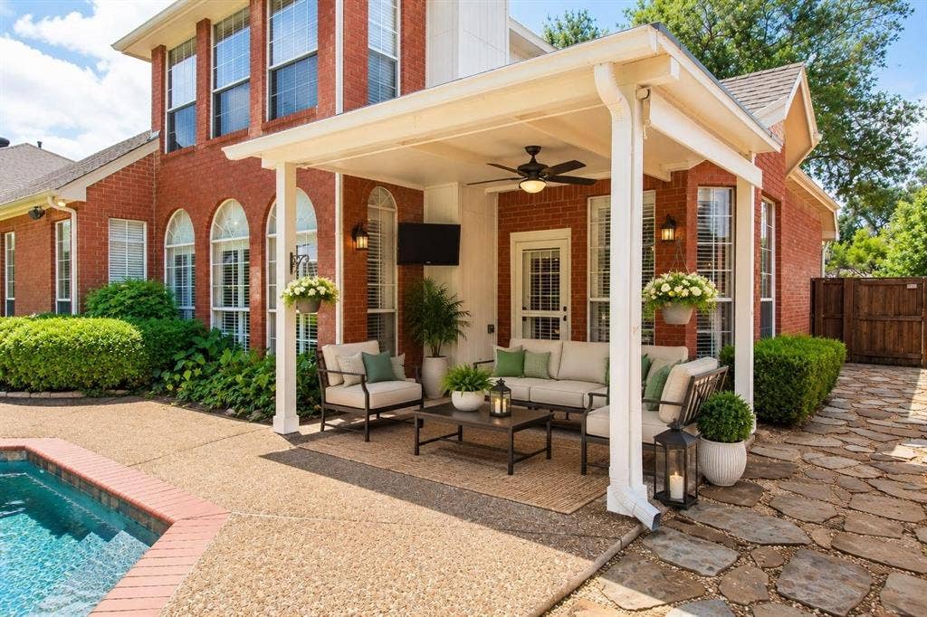 12004 Paducah Drive, Frisco, TX 75035 Outdoor living at its best: covered patio with ceiling fan and sparkling pool views. Virtually staged.