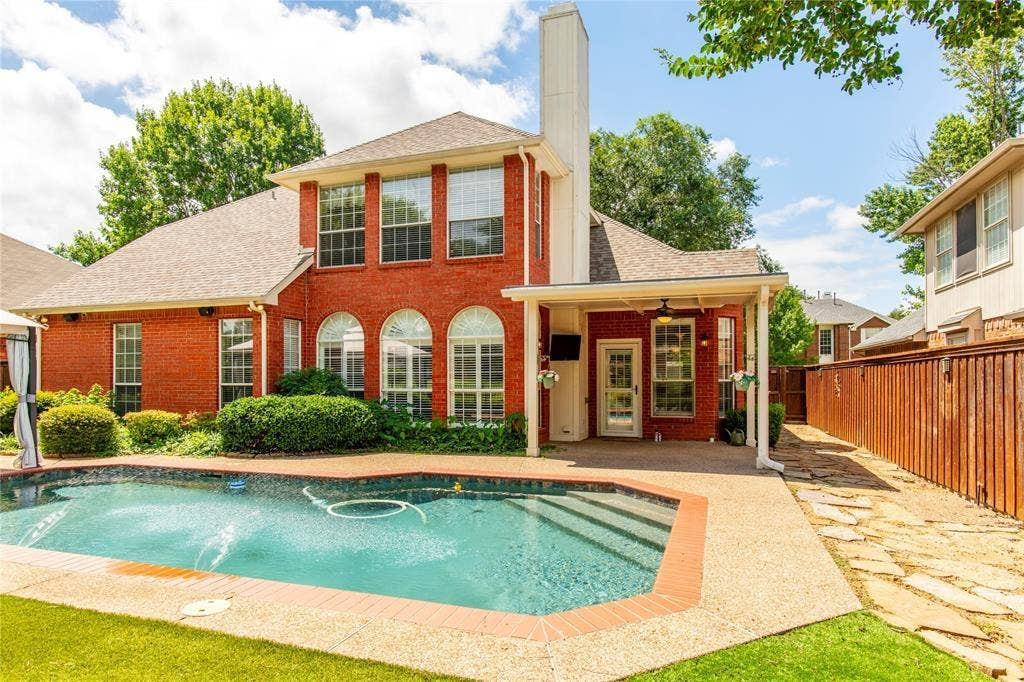 12004 Paducah Drive, Frisco, TX 75035 Resort-style backyard oasis! Sparkling private pool framed by a classic brick two-story - your own staycation every day.