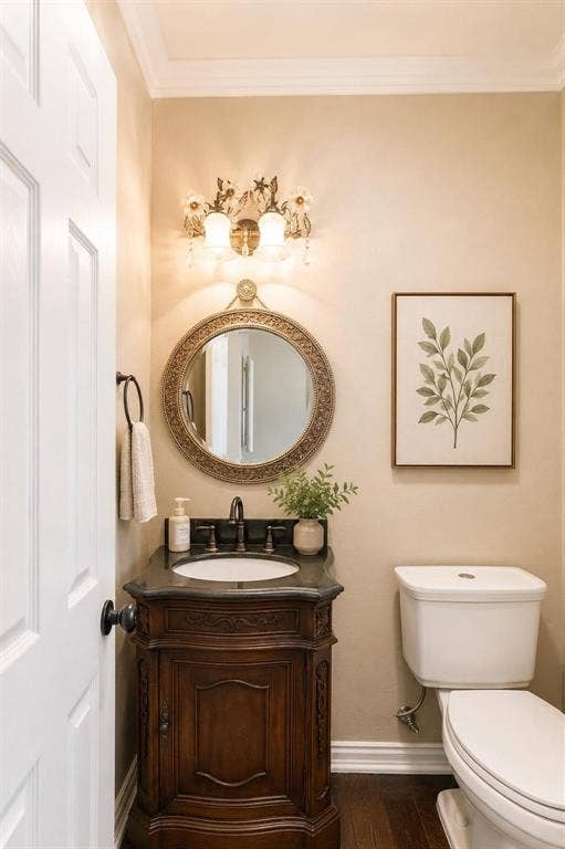 12004 Paducah Drive, Frisco, TX 75035 Stylish powder bath with rich wood vanity and designer mirror - convenient for guests.