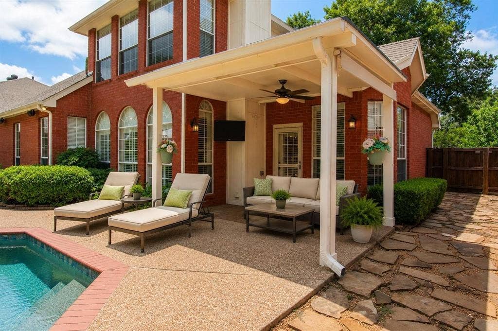 12004 Paducah Drive, Frisco, TX 75035 Covered back patio steps from the pool - lounge, grill and relax in the shade. Virtually staged.
