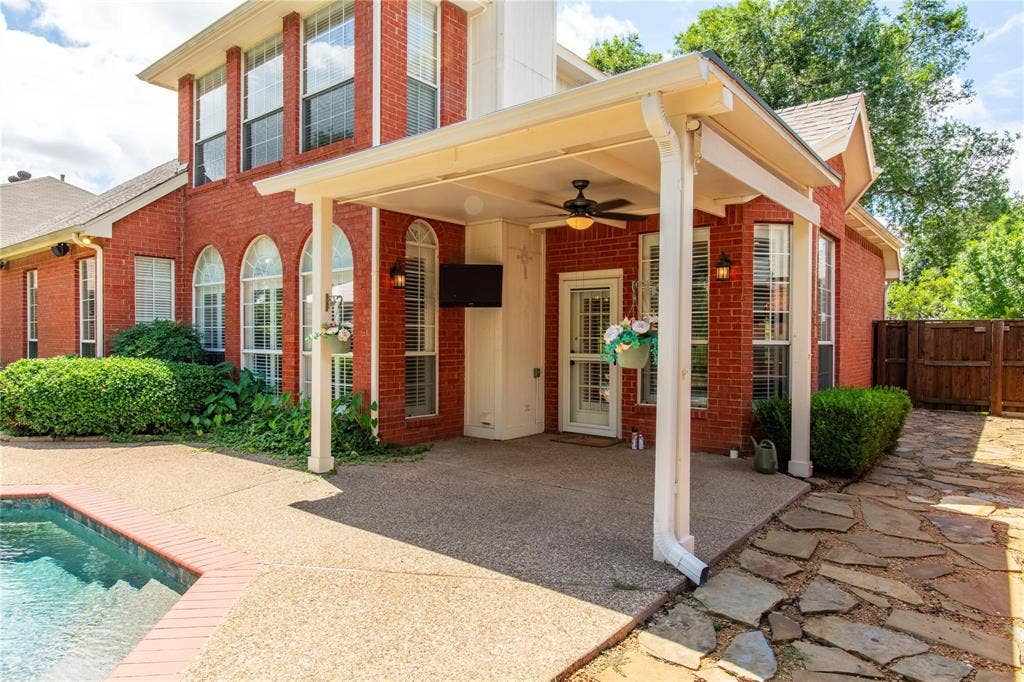 12004 Paducah Drive, Frisco, TX 75035 Classic brick two-story with covered patio and pool - private backyard living at its finest.