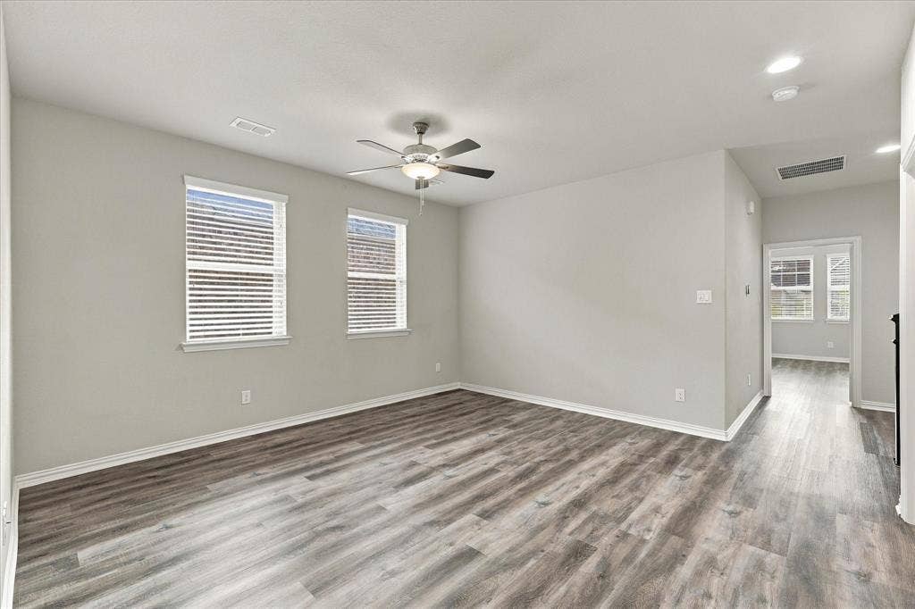 614 Ansley Way, Allen, TX 75013 Neutral-toned interior featuring wood-finish flooring, a ceiling fan with integrated lighting, recessed lighting, and double-paned windows