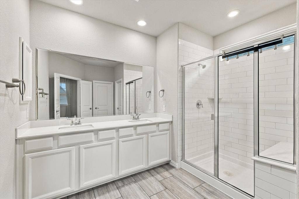 614 Ansley Way, Allen, TX 75013 Double vanity with white cabinetry, rectangular under-mount sinks, and large wall-to-wall mirror