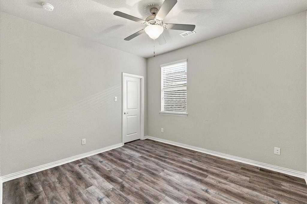 614 Ansley Way, Allen, TX 75013 Room featuring wood-finish flooring, a ceiling fan with integrated lighting, and a window with blinds