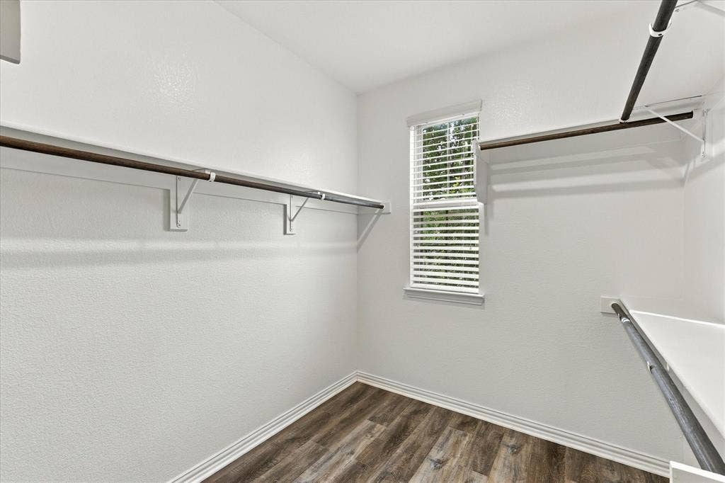 614 Ansley Way, Allen, TX 75013 Walk-in closet featuring wood-finish flooring, white walls, horizontal window blinds, and tiered metal shelving rods