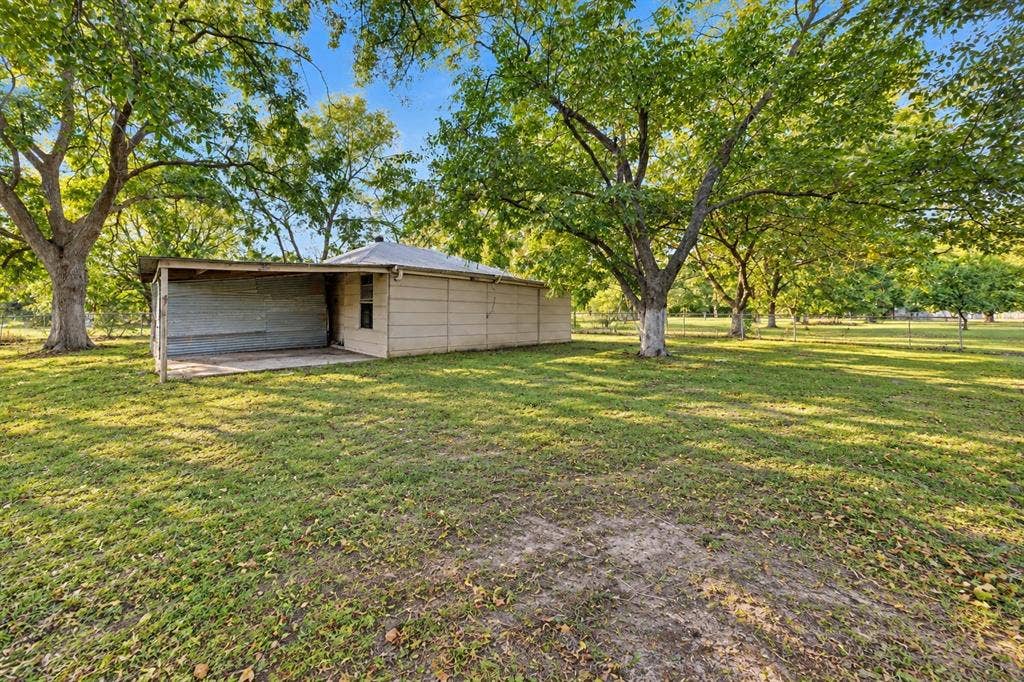 2415 Fannin Street, Greenville, TX 75401 Shop with electricity and a large sliding door for convenient access and versatile storage or workspace options.