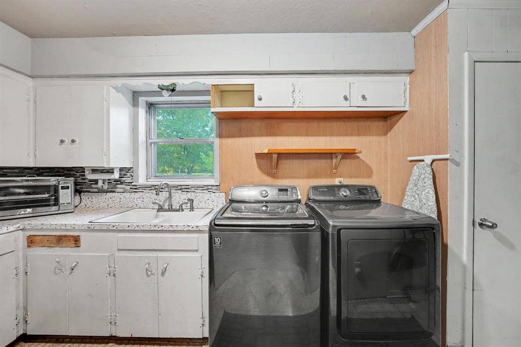 2415 Fannin Street, Greenville, TX 75401 Spacious utility room with a second sink and additional pantry storage.