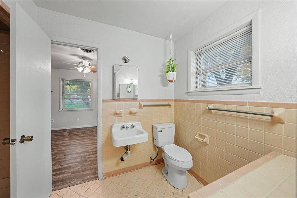 2415 Fannin Street, Greenville, TX 75401 Jack and Jill bathroom conveniently connecting two bedrooms for added functionality and privacy.