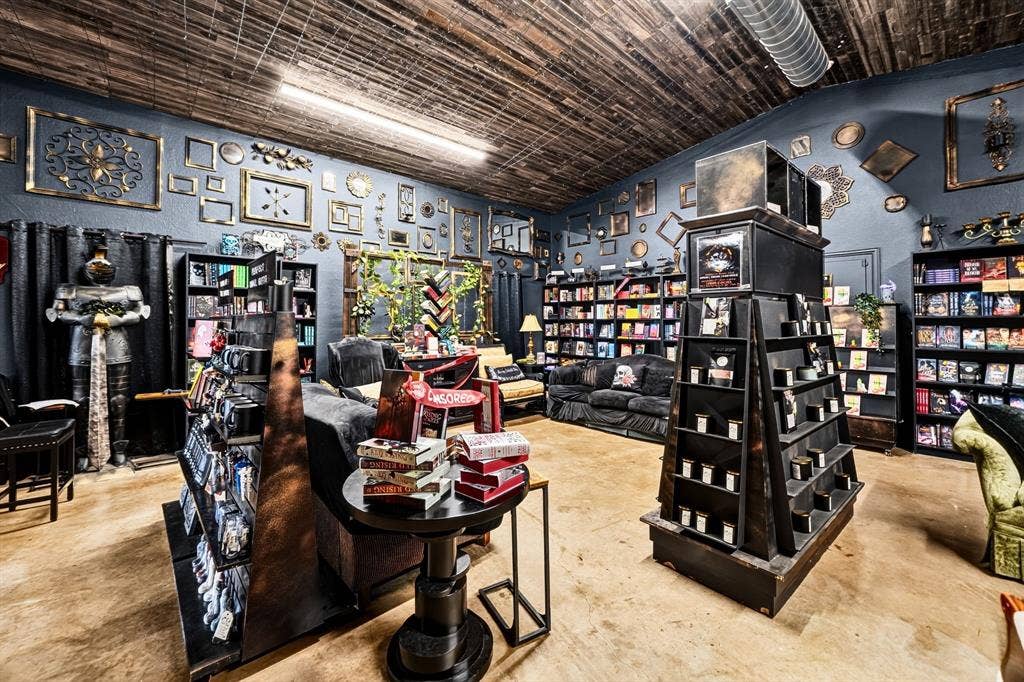 911 W Holiday Drive, Fate, TX 75132 Vaulted wood-plank ceiling, polished concrete flooring, and built-in shelving units
