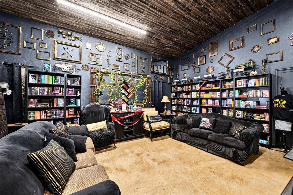 911 W Holiday Drive, Fate, TX 75132 Room featuring wood-plank ceiling, stained concrete flooring, and built-in floor-to-ceiling shelving