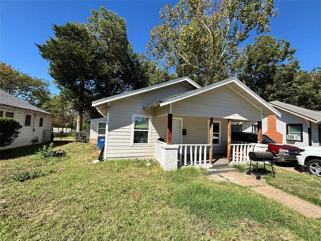 2917 Lenway Street, Dallas, TX 75215 Single-story exterior featuring light-toned horizontal siding, a covered front porch with painted brick columns, and a gabled roofline