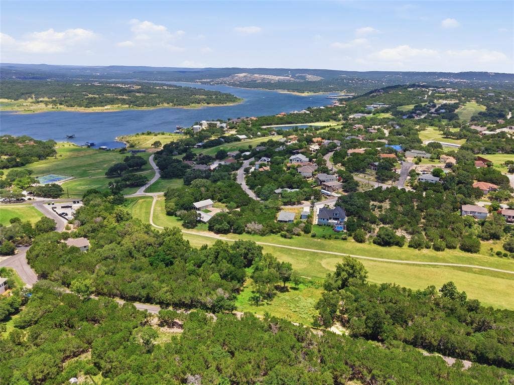 Aerial perspective featuring proximity to a large reservoir, expansive green space, mature tree canopy, and established road infrastructure