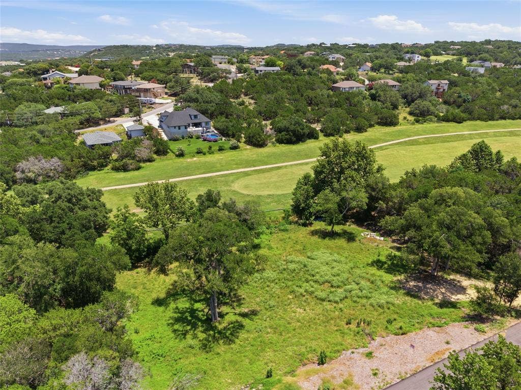Expansive parcel featuring mature trees, native vegetation, and direct frontage on a grassed fairway