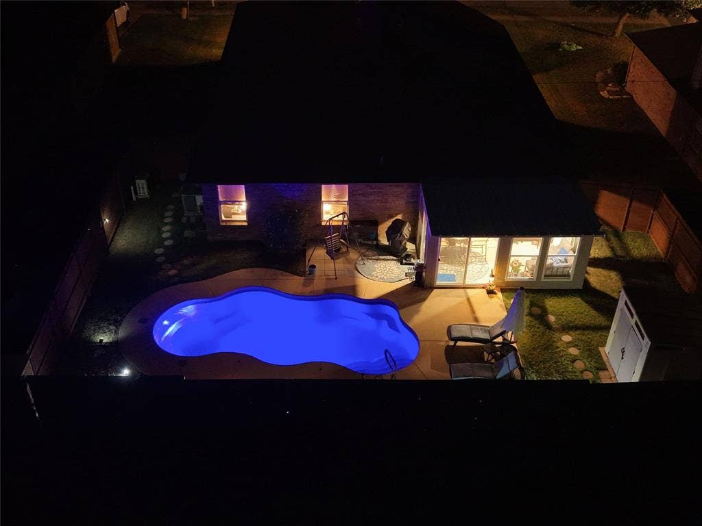Backyard and pool after dark