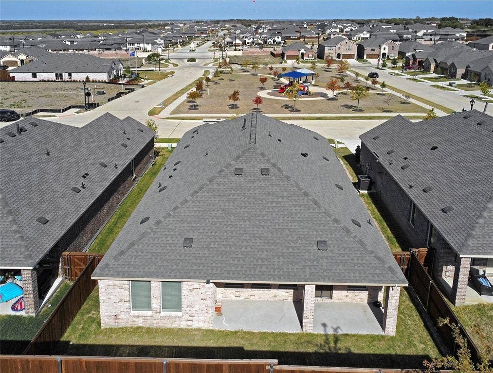 2504 Clyde Road, Celina, TX 75009 Aerial view featuring a brick exterior, covered rear patio, shingle roof, and a fenced backyard