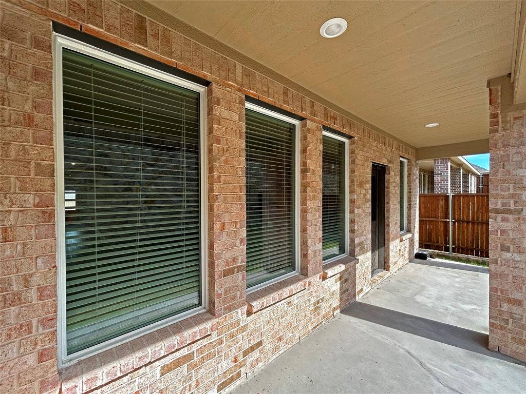 2504 Clyde Road, Celina, TX 75009 Covered patio featuring a concrete floor, recessed lighting, brick exterior walls, and multiple large windows
