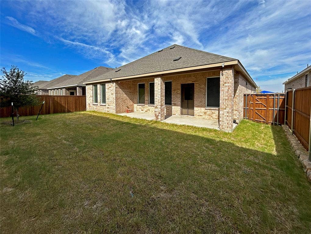 2504 Clyde Road, Celina, TX 75009 Backyard featuring a masonry exterior, a covered concrete patio, and a wood privacy fence