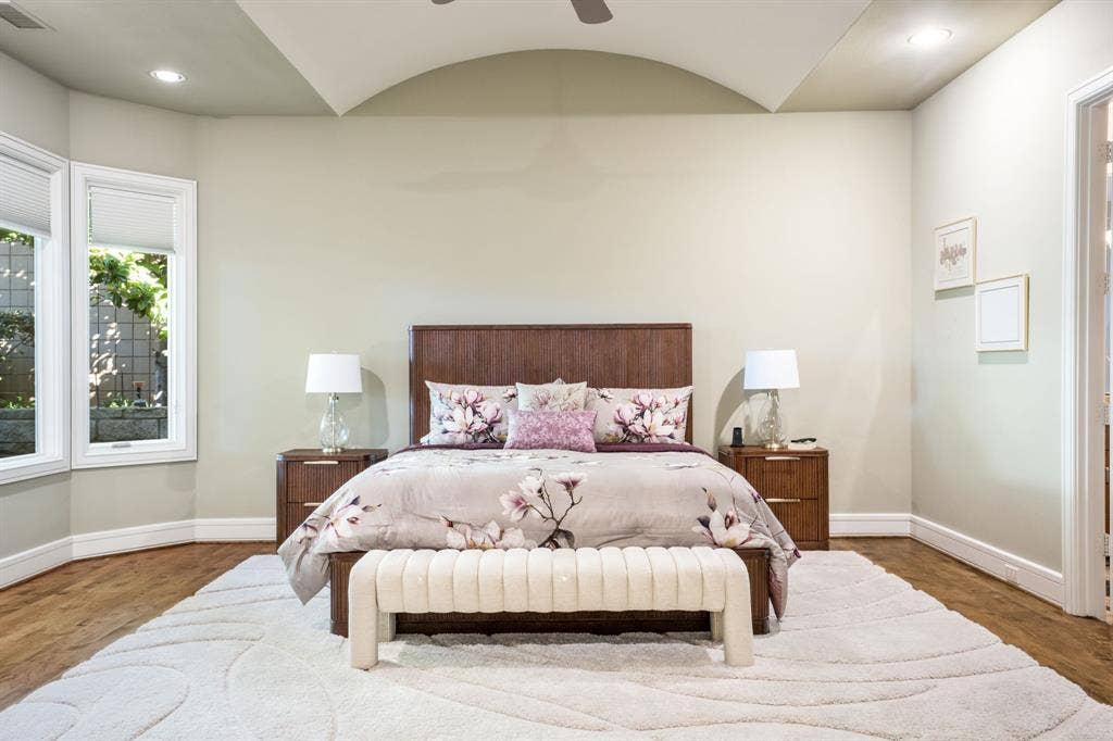 Barrel-vaulted ceiling, wood-finish flooring, recessed lighting, and multi-pane windows