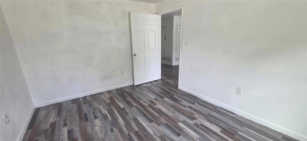 3510 Marshall Street, Greenville, TX 75401 Interior room featuring wood-finish flooring and a six-panel door
