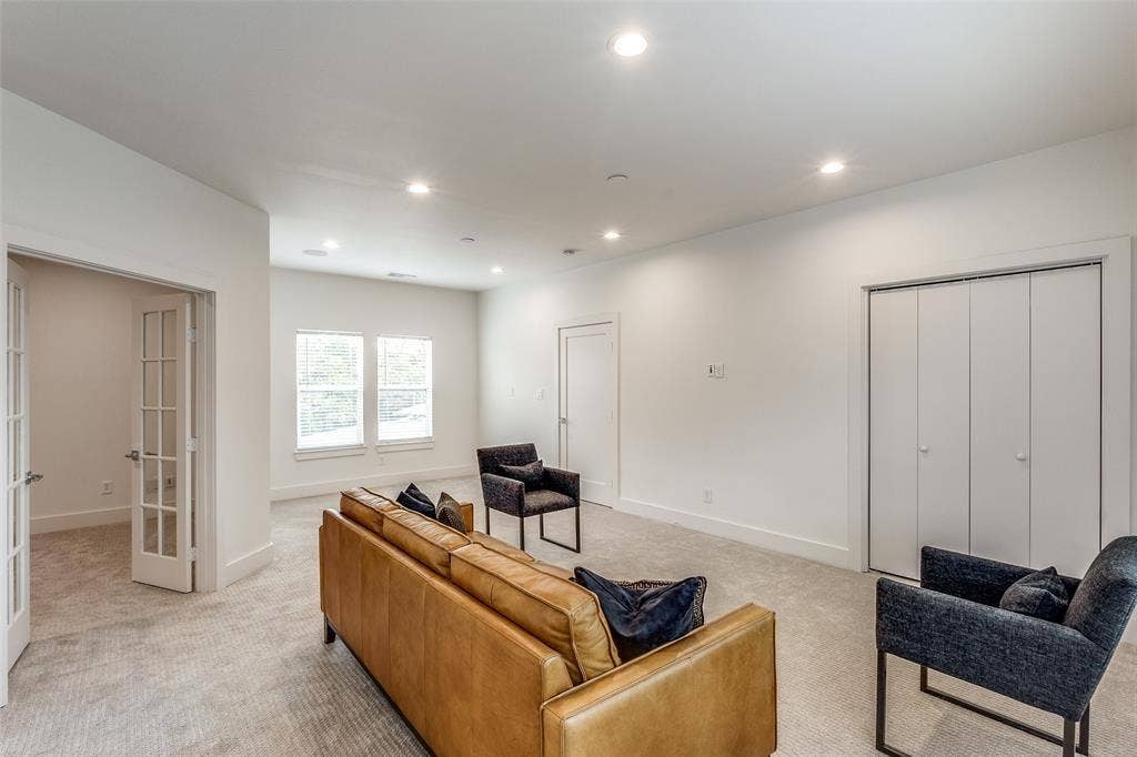 Neutral interior featuring recessed lighting, plush wall-to-wall carpeting, two-panel bifold closet doors, and a glass-paneled French door