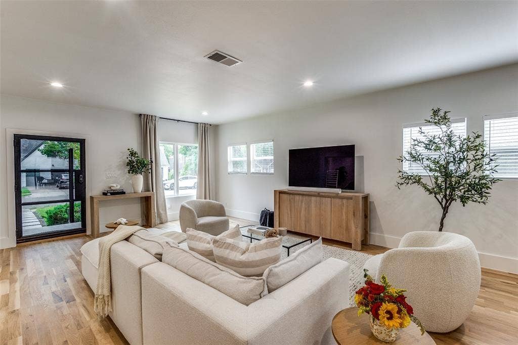 Interior living space featuring wood-finish flooring, recessed lighting, and a multi-pane glass entry door