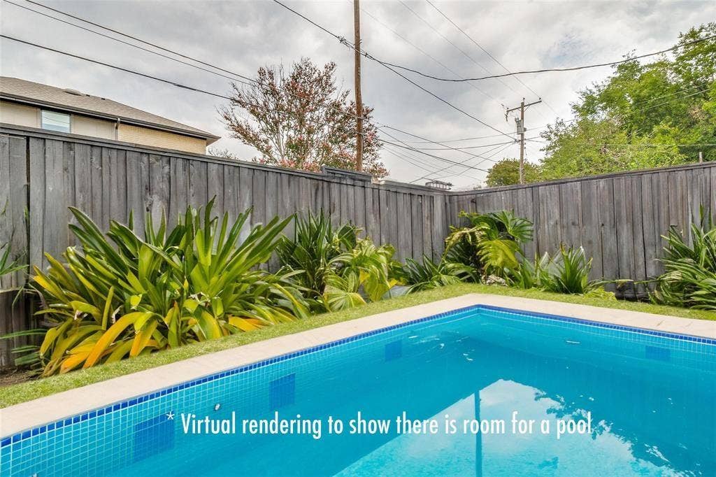 Private backyard featuring a perimeter wood-plank fence and mature landscaping