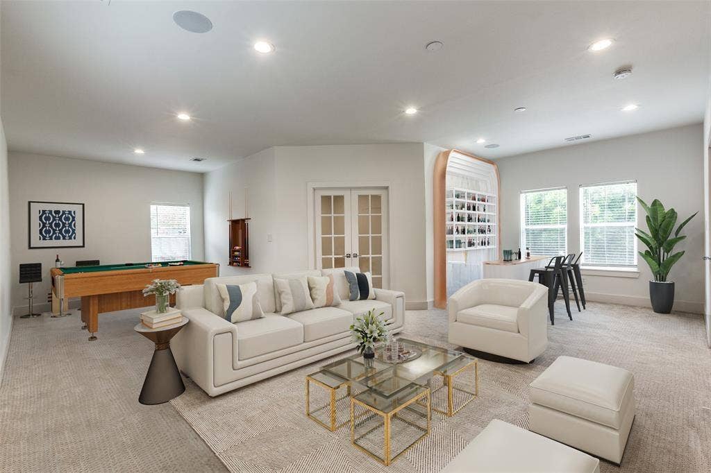 Built-in arched wet bar with recessed shelving, recessed lighting, double French doors, and multi-pane windows